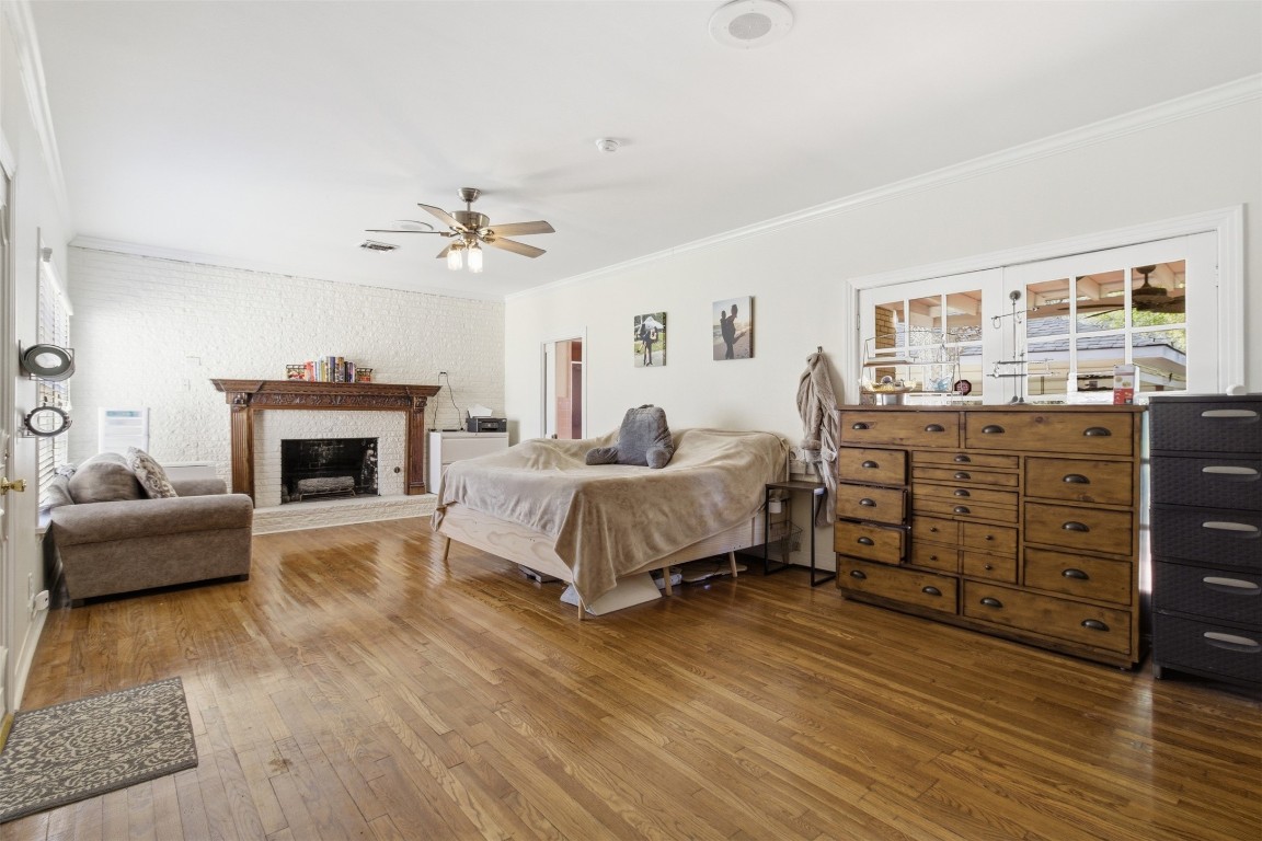 829 Bear Drive Timpson, TX 75975 - Photo 19 of 47 a spacious bedroom with a bed a fireplace and a couch