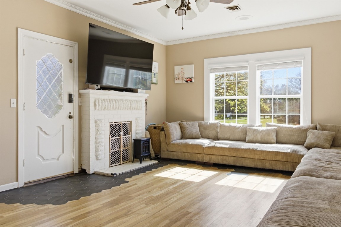 829 Bear Drive Timpson, TX 75975 - Photo 6 of 47 a living room with furniture a flat screen tv and a fireplace