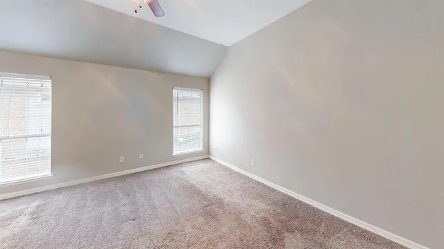 an empty room with windows and closet