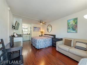 2555 9th Street North, Unit 109 Naples, FL 34103 - Photo 6 of 6 a living room with furniture and a wooden floor