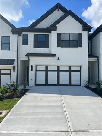 a front view of a house with garage