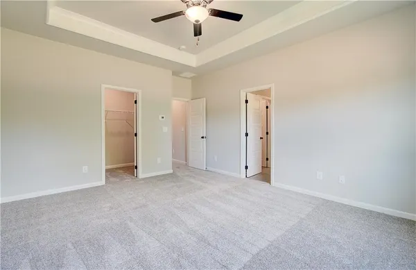 an empty room with fan and entrance