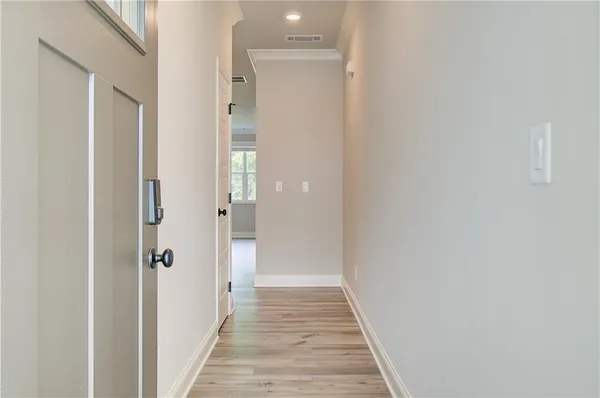 a view of a hallway with wooden floor