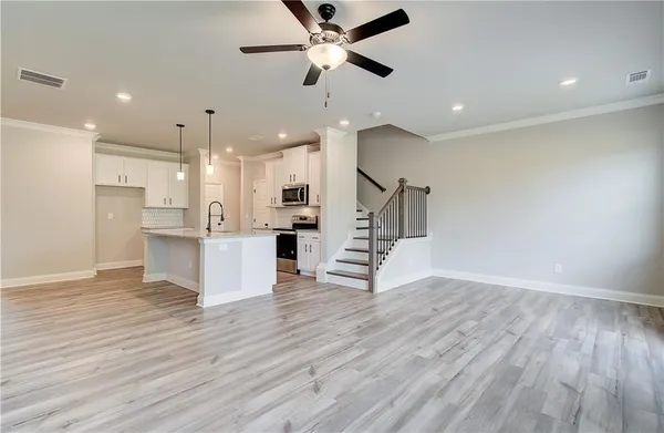 a view of kitchen with cabinets and wooden floor
