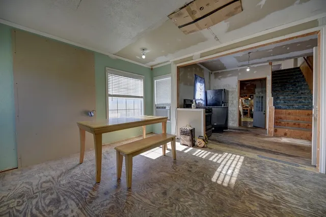 a living room with furniture a dining table and chairs with wooden floor