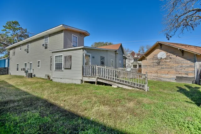 a view of a house with a yard and deck
