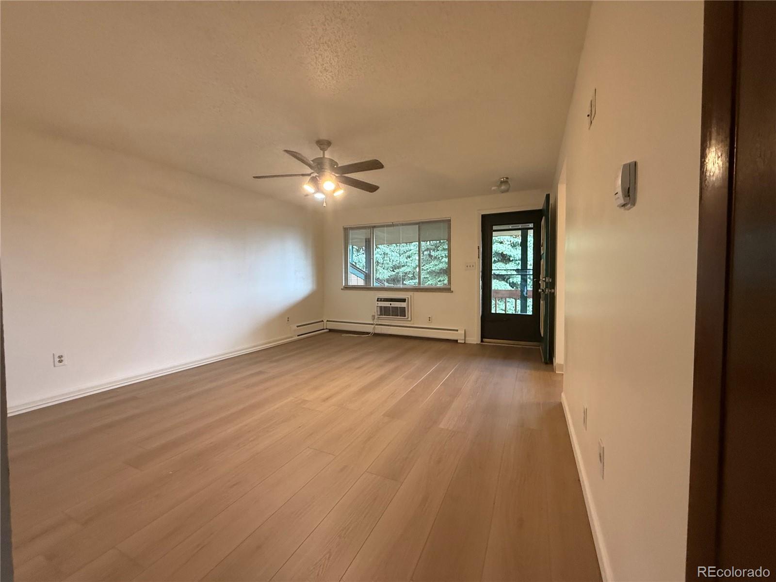 6155 Simms Street, Unit 2 Arvada, CO 80004 - Photo 7 of 7 wooden floor in an empty room with a window