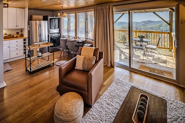 a living room with furniture and a floor to ceiling window