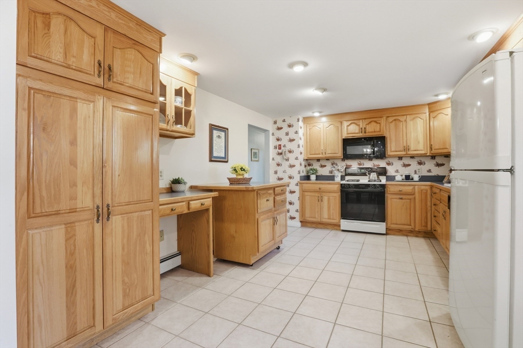 2 Glenwood Road Andover, MA 01810 - Photo 11 of 42 a kitchen with stainless steel appliances granite countertop a refrigerator sink and cabinets
