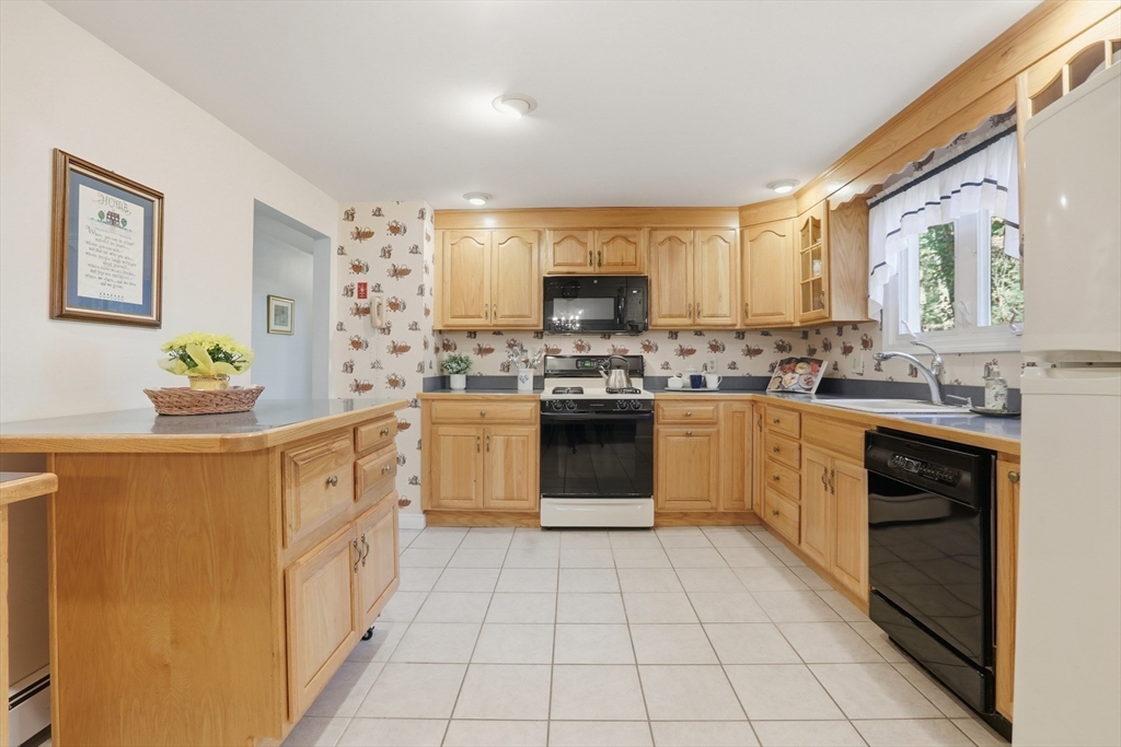 2 Glenwood Road Andover, MA 01810 - Photo 12 of 42 a kitchen with stainless steel appliances granite countertop a stove sink and cabinets