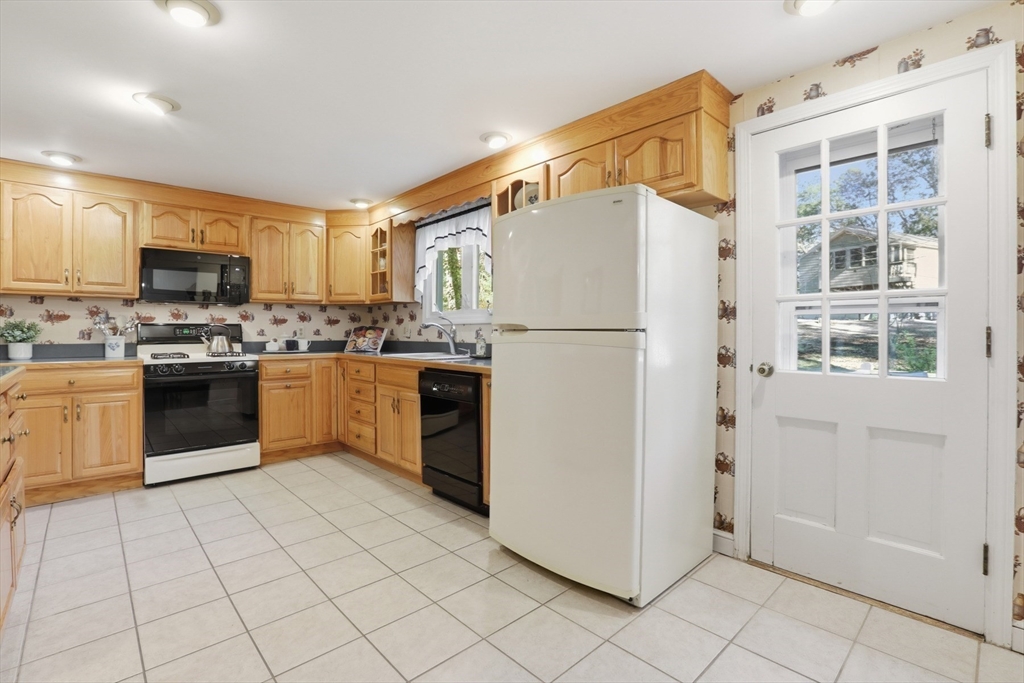 2 Glenwood Road Andover, MA 01810 - Photo 14 of 42 a kitchen with stainless steel appliances granite countertop a refrigerator sink a stove a microwave and island