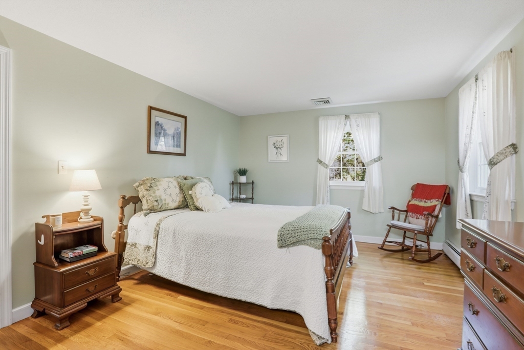2 Glenwood Road Andover, MA 01810 - Photo 19 of 42 a bedroom with a bed and a chair