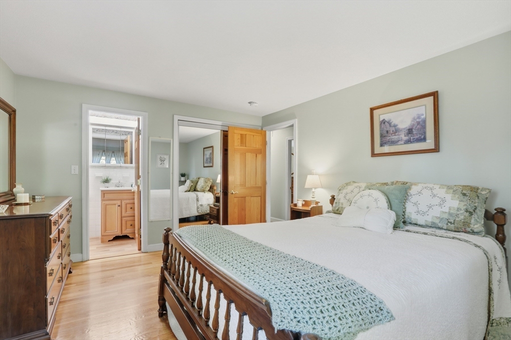 2 Glenwood Road Andover, MA 01810 - Photo 20 of 42 a bedroom with a large bed and a chandelier