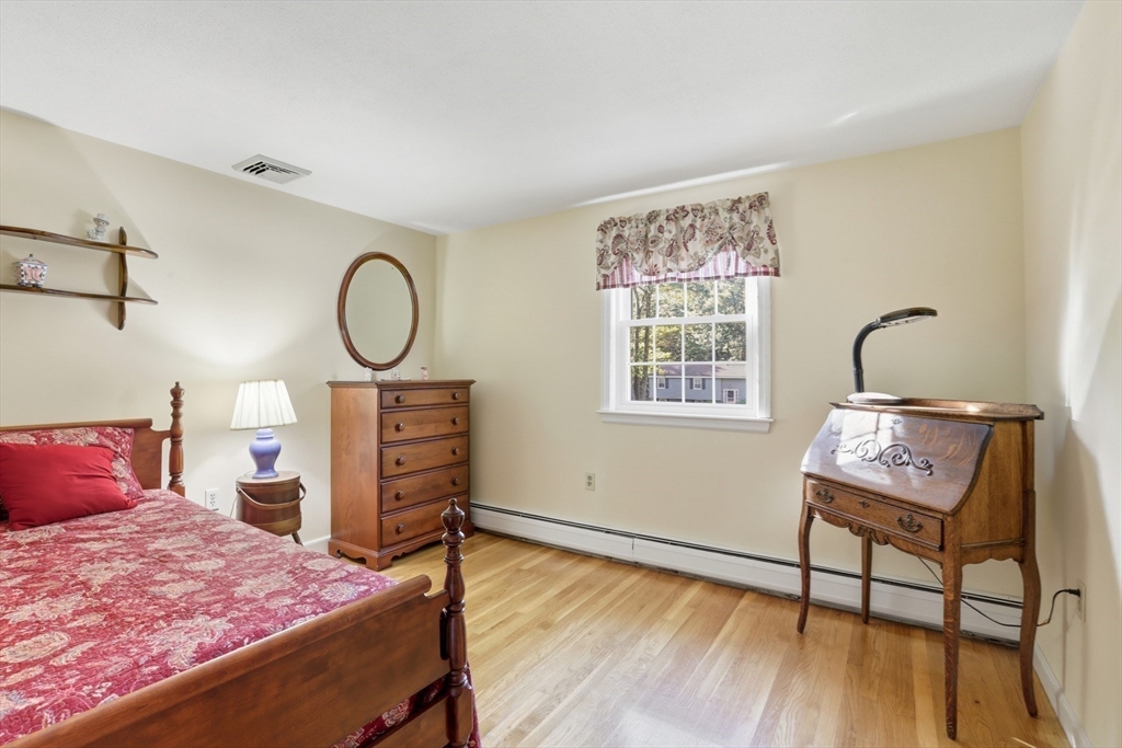 2 Glenwood Road Andover, MA 01810 - Photo 24 of 42 a bedroom with a bed a dresser and wooden floor