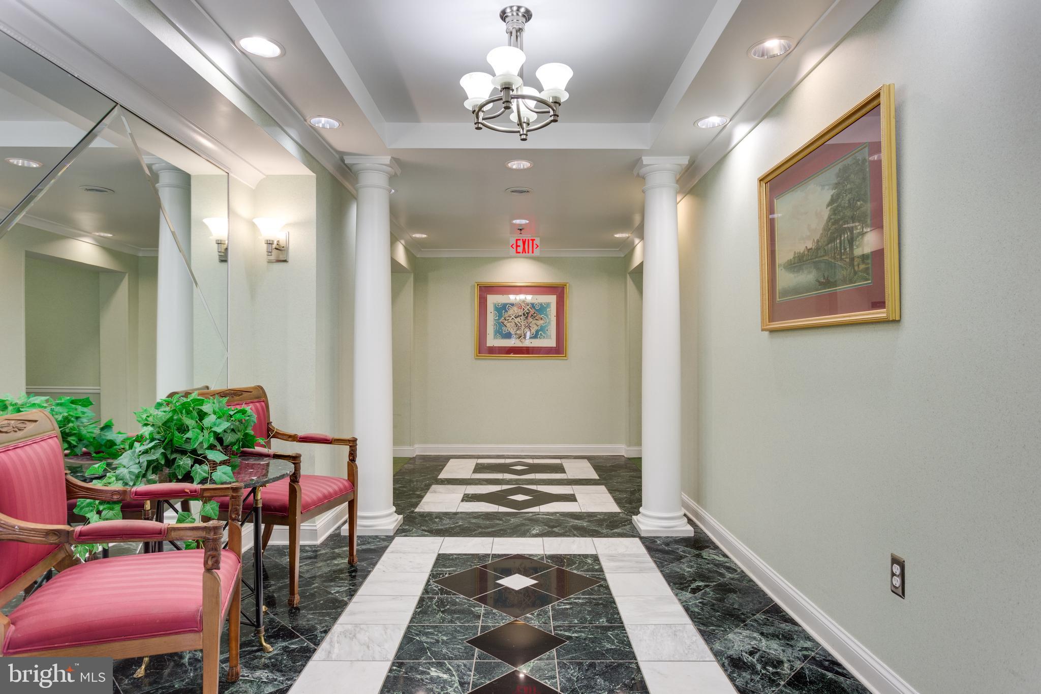 5565 Seminary Road, Unit 113 Falls Church, VA 22041 - Photo 2 of 19 a view of a hallway with furniture and a potted plant