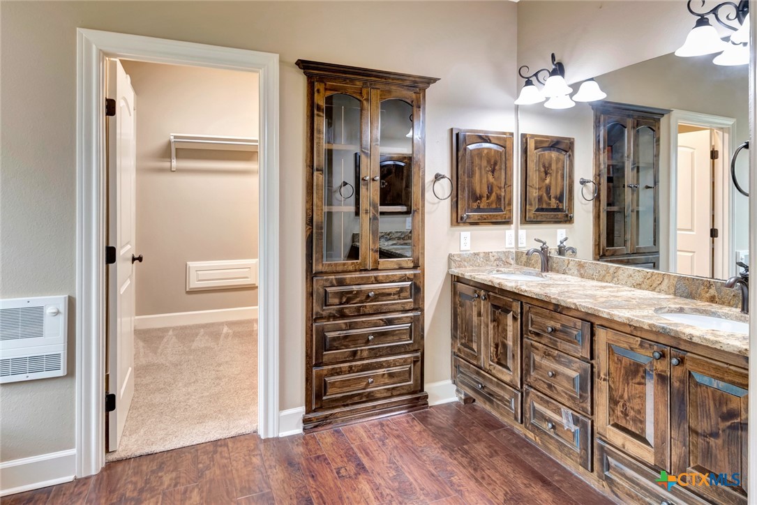 249 Post Oak Bend Inez, TX 77968 - Photo 14 of 36 a bathroom with a double vanity sink and a mirror