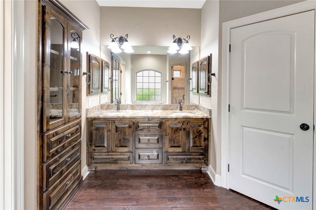 249 Post Oak Bend Inez, TX 77968 - Photo 15 of 36 a bathroom with a double vanity sink and a mirror