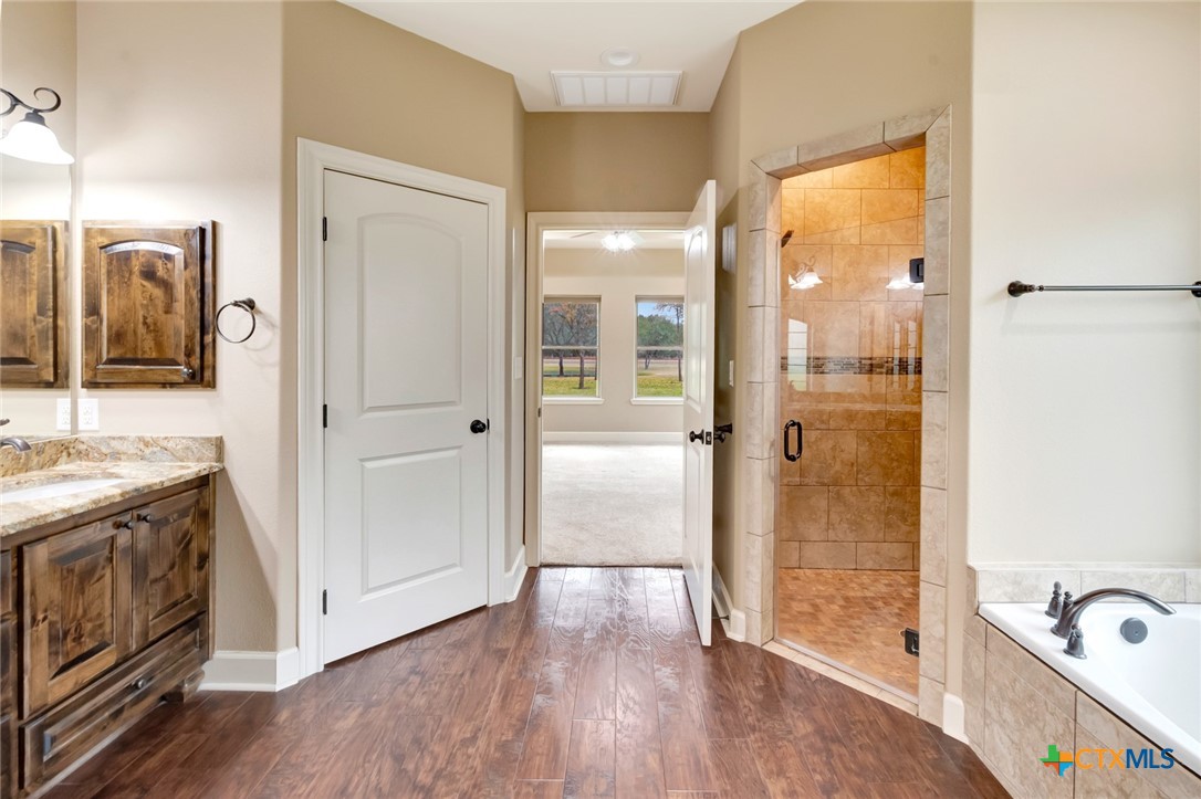 249 Post Oak Bend Inez, TX 77968 - Photo 16 of 36 a bathroom with a granite countertop tub sink and mirror