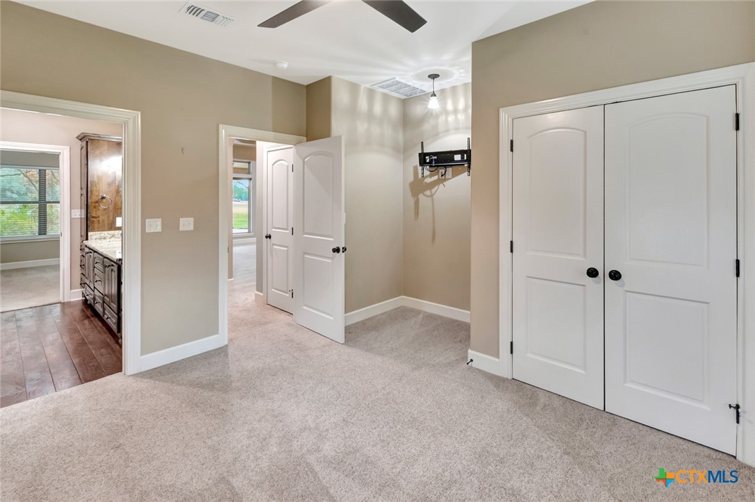 249 Post Oak Bend Inez, TX 77968 - Photo 18 of 36 a view of a hallway with wooden floor and a bathroom