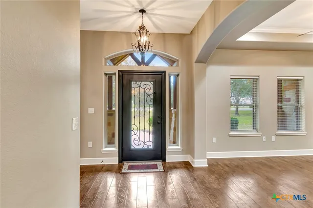 a view of an entryway with wooden floor and door