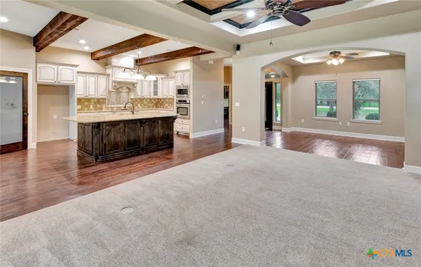 a view of a kitchen with a sink and a fireplace