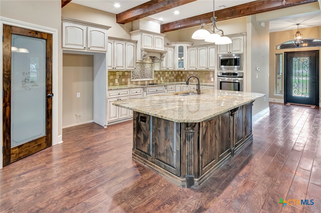 249 Post Oak Bend Inez, TX 77968 - Photo 9 of 36 a kitchen with stainless steel appliances granite countertop a kitchen island a hardwood floor and a view of living room
