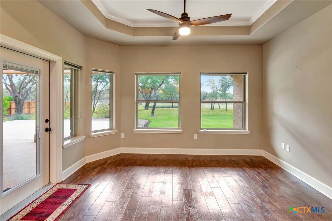 249 Post Oak Bend Inez, TX 77968 - Photo 10 of 36 an empty room with wooden floor fan and windows