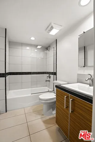 a bathroom with a sink a toilet and bathtub