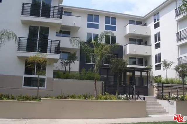 a front view of a building with a garden
