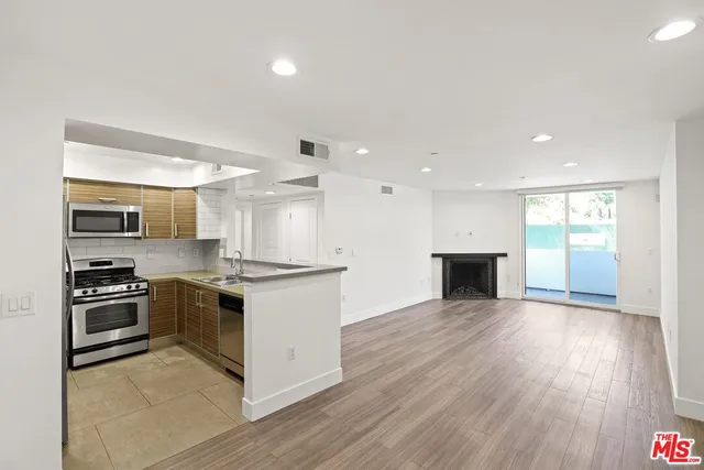 a kitchen with stainless steel appliances granite countertop a stove top oven and sink
