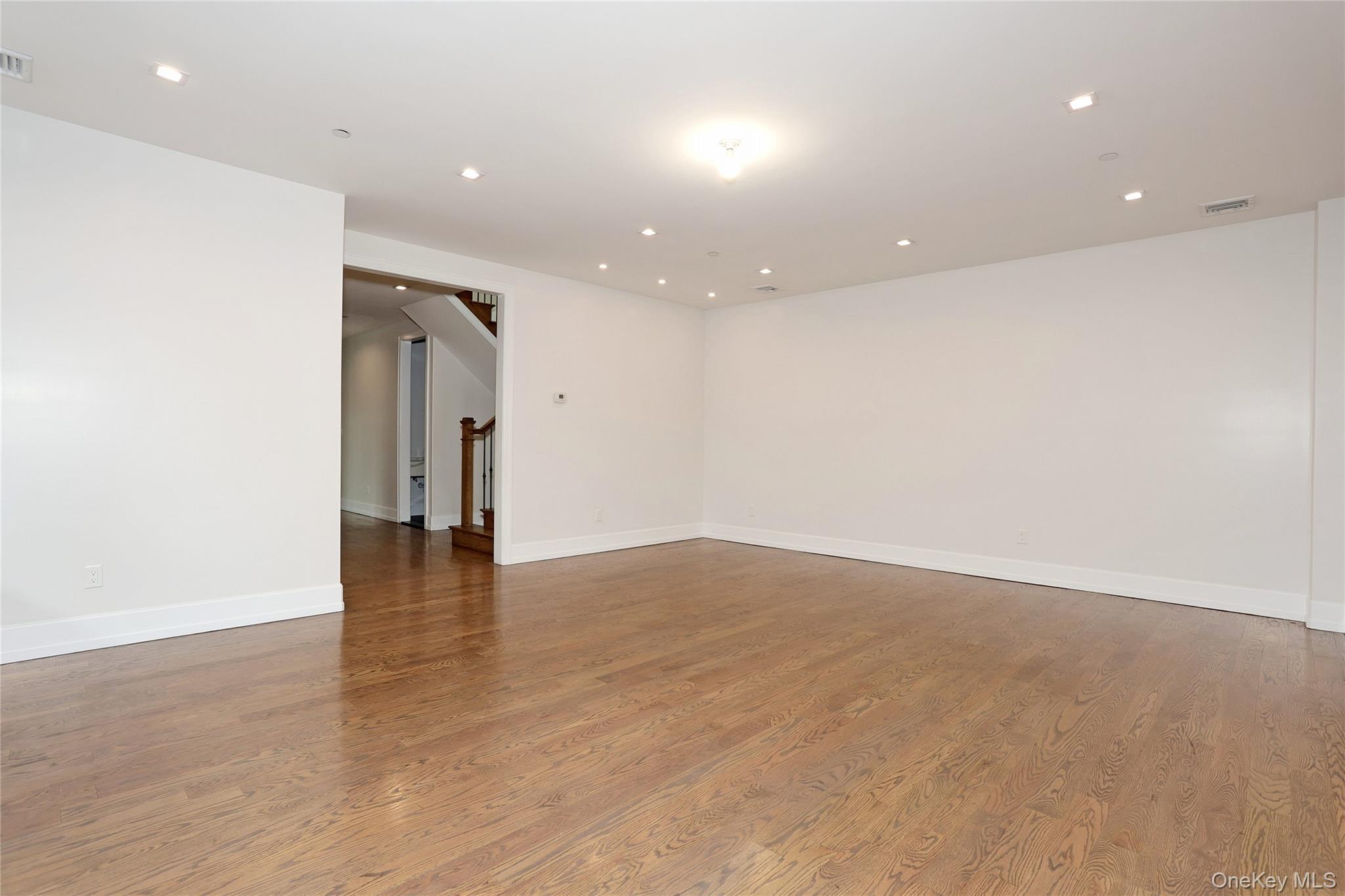 8 Neil Road, Unit 213 Spring Valley, NY 10977 - Photo 11 of 50 an empty room with wooden floor and natural light