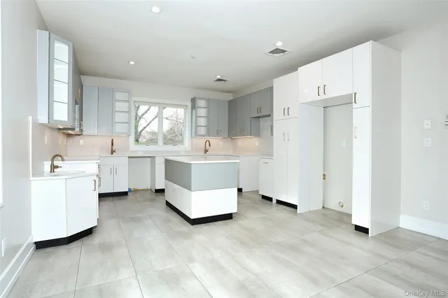 a utility room with cabinets washer and dryer