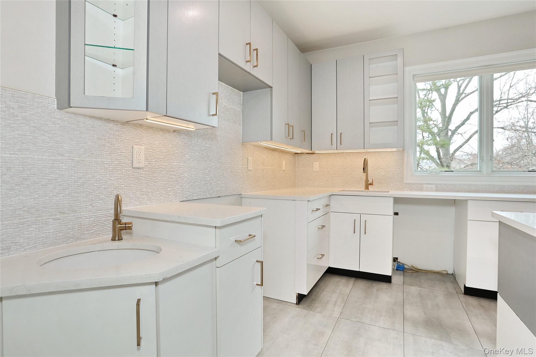 8 Neil Road, Unit 213 Spring Valley, NY 10977 - Photo 16 of 50 a kitchen with white cabinets appliances a sink and a window