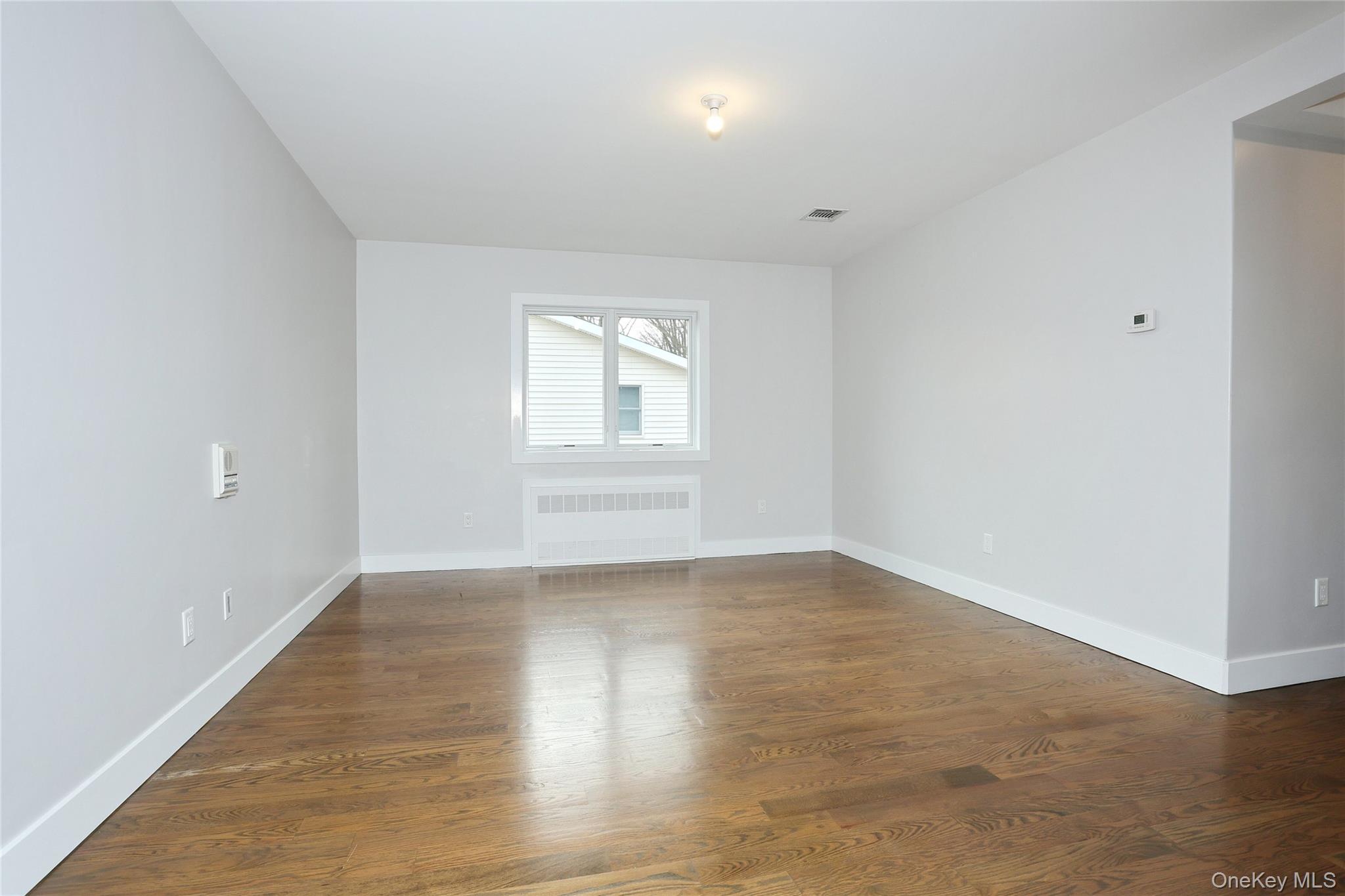 8 Neil Road, Unit 213 Spring Valley, NY 10977 - Photo 26 of 50 an empty room with wooden floor and windows