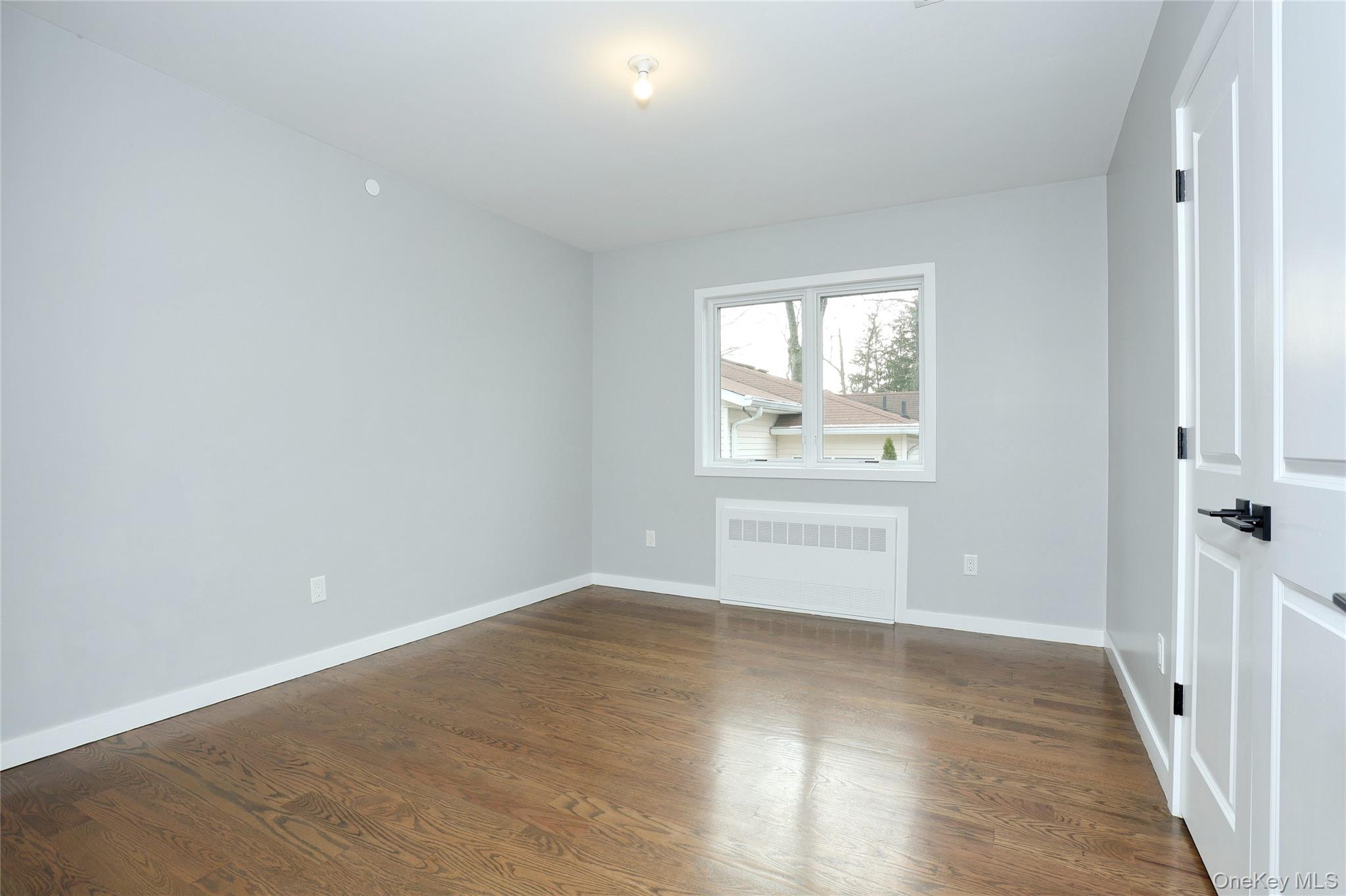8 Neil Road, Unit 213 Spring Valley, NY 10977 - Photo 31 of 50 wooden floor in an empty room with a window