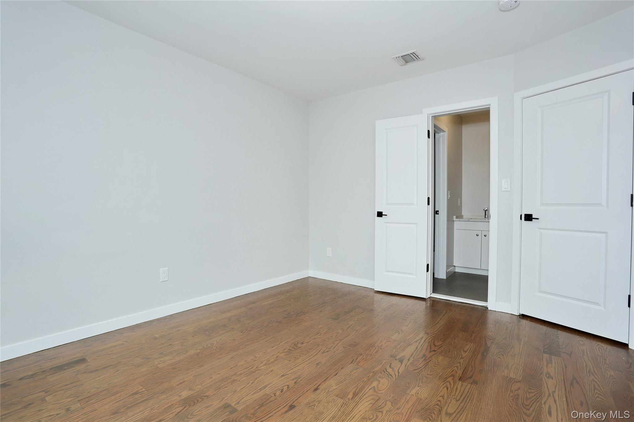 8 Neil Road, Unit 213 Spring Valley, NY 10977 - Photo 33 of 50 a view of an empty room with wooden floor and closet