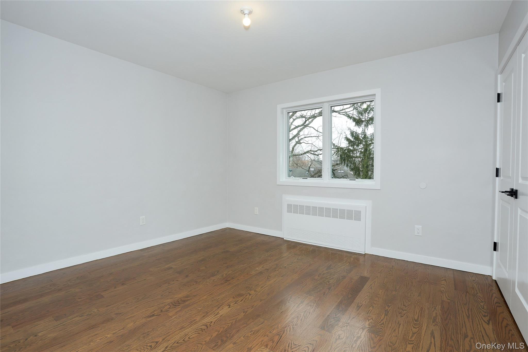 8 Neil Road, Unit 213 Spring Valley, NY 10977 - Photo 37 of 50 an empty room with wooden floor and windows
