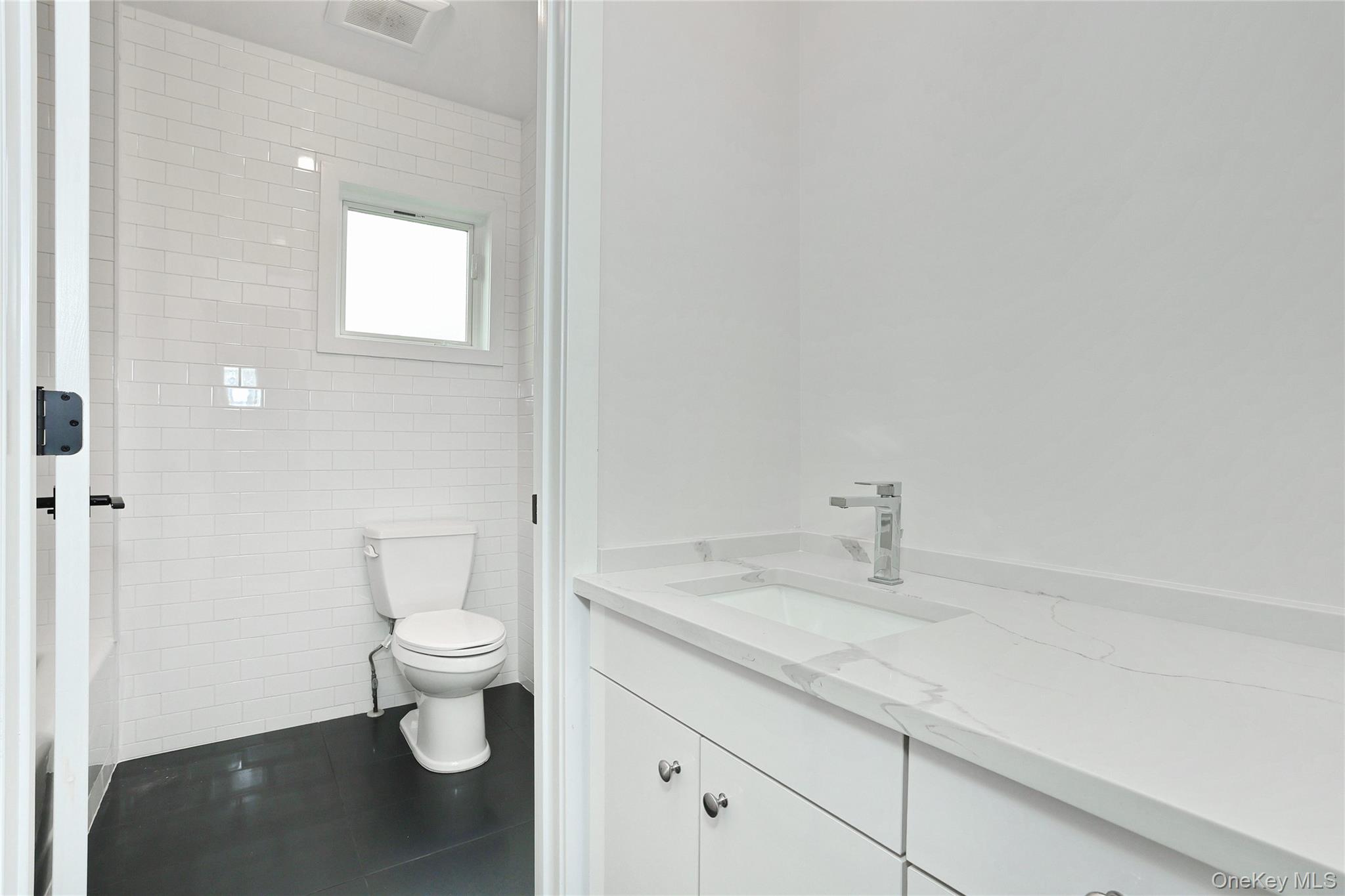 8 Neil Road, Unit 213 Spring Valley, NY 10977 - Photo 38 of 50 a bathroom with a granite countertop sink and a toilet