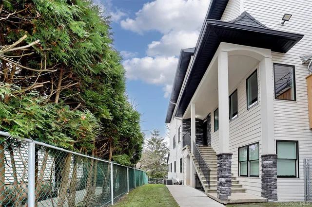 a view of a house with a small yard