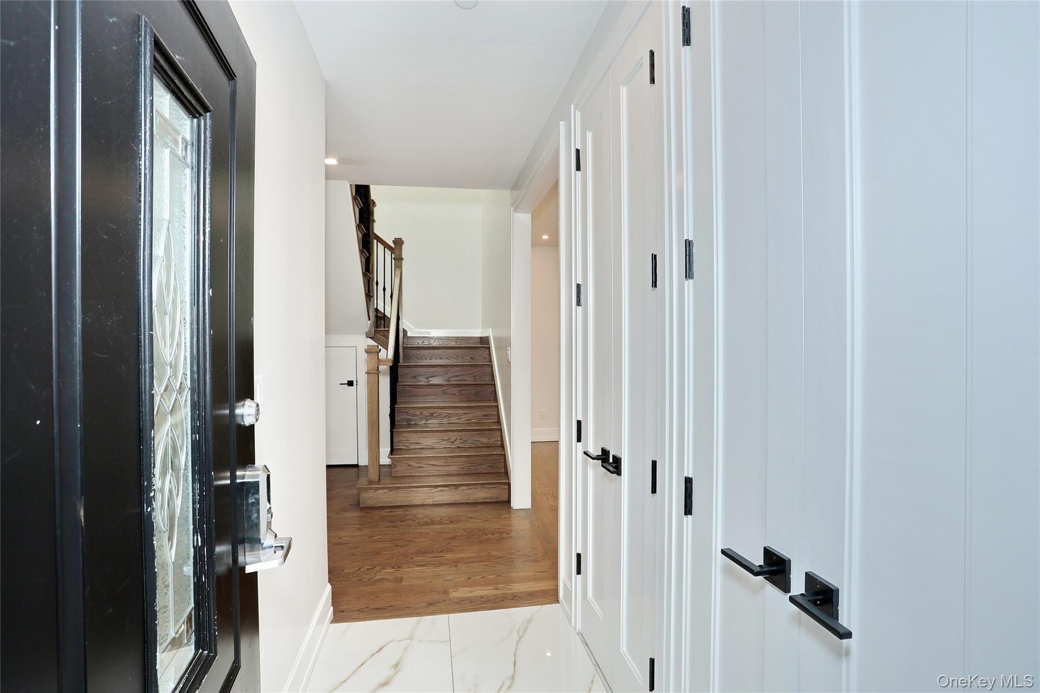8 Neil Road, Unit 213 Spring Valley, NY 10977 - Photo 6 of 50 a view of a hallway with wooden floor and staircase