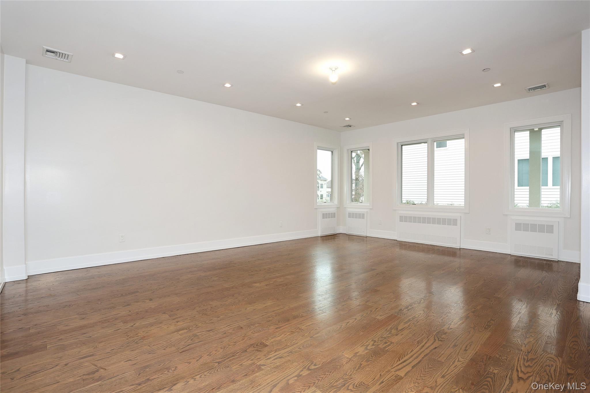 8 Neil Road, Unit 213 Spring Valley, NY 10977 - Photo 9 of 50 an empty room with wooden floor and windows