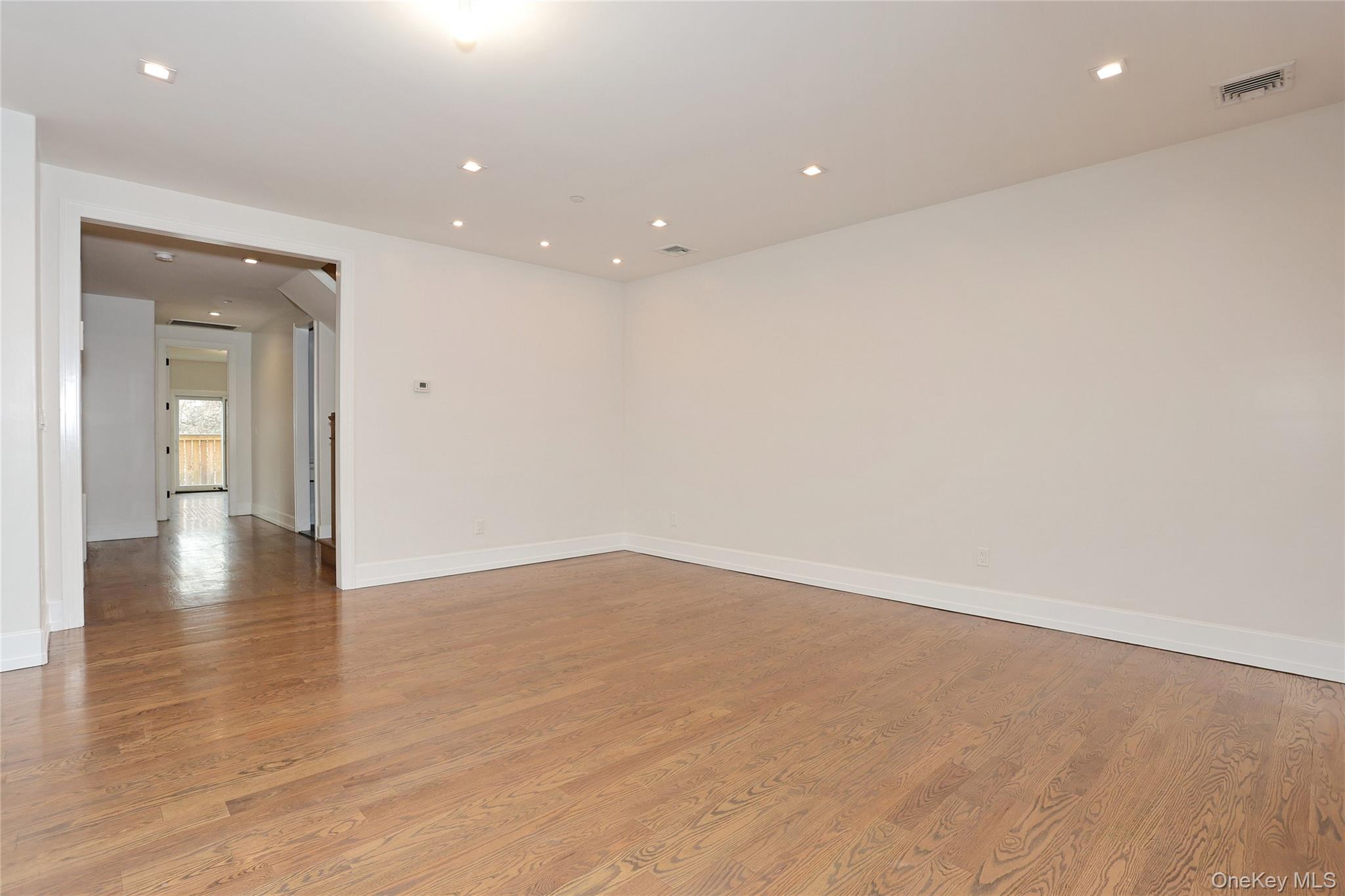 8 Neil Road, Unit 213 Spring Valley, NY 10977 - Photo 10 of 50 an empty room with wooden floor and windows
