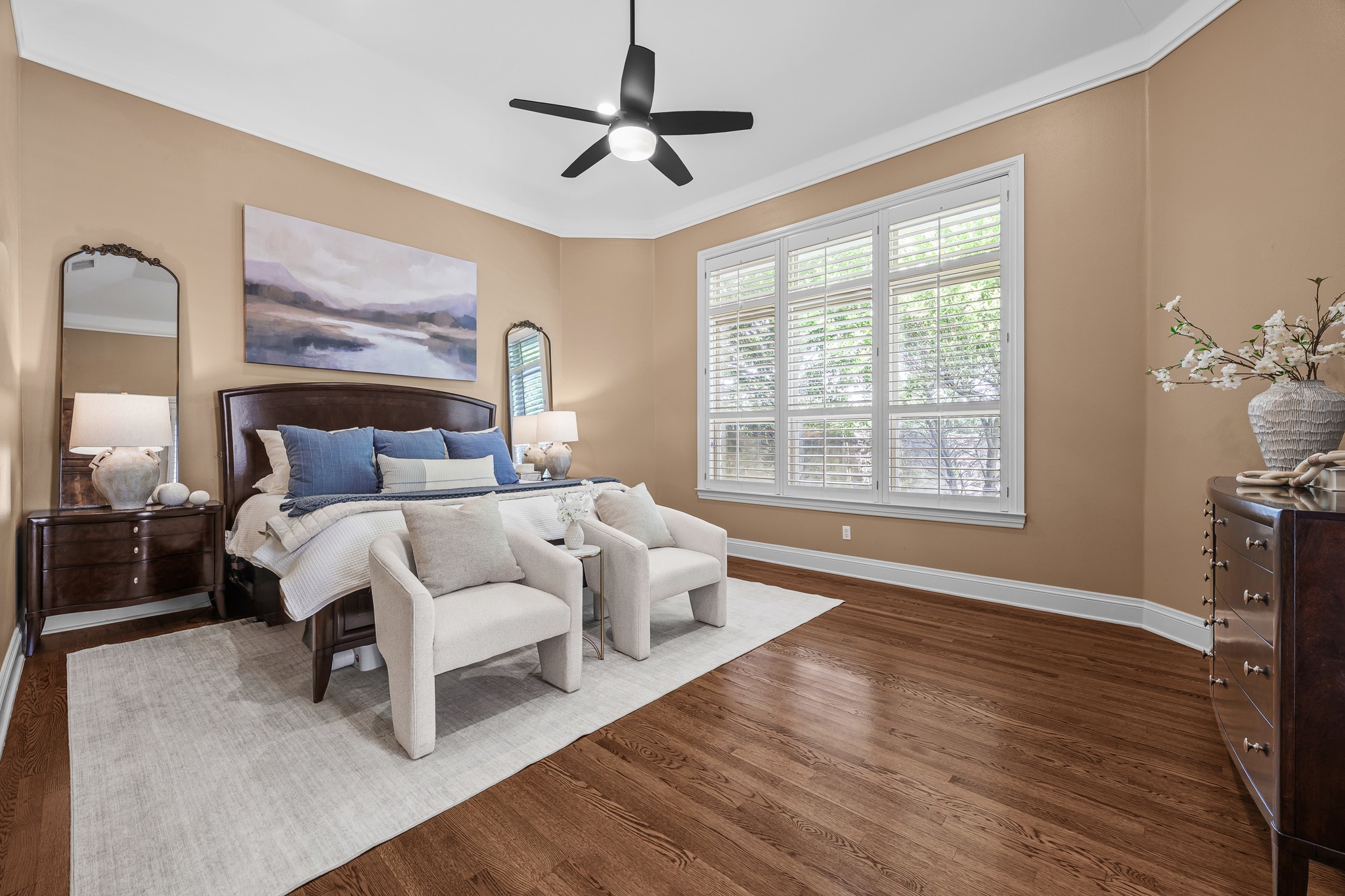 5200 Rico Cove Austin, TX 78731 - Photo 17 of 40 Warm hardwood floors and classic crown molding frame this restful, light-filled bedroom.