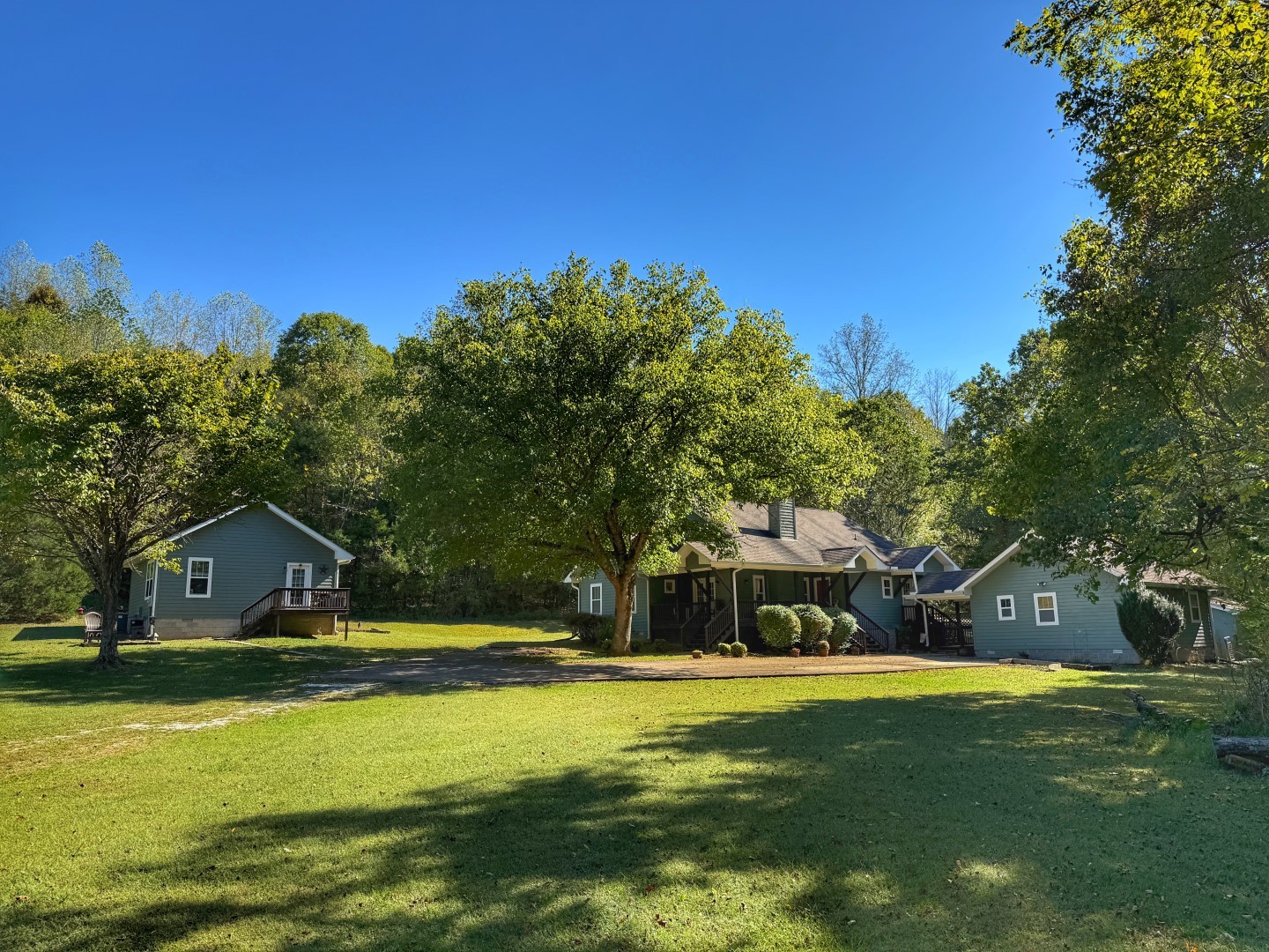 a view of house with swimming pool and yard