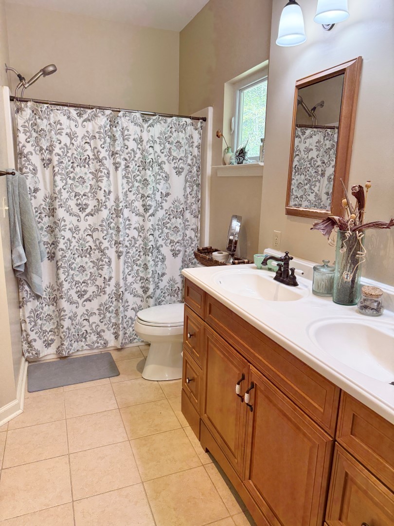 1381 Turkey Creek Road Dickson, TN 37055 - Photo 13 of 35 a bathroom with a sink a toilet and shower curtain