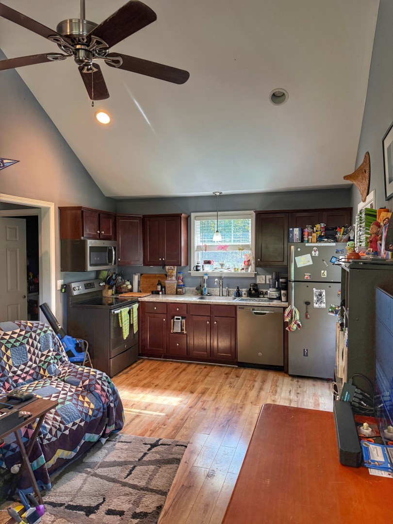 1381 Turkey Creek Road Dickson, TN 37055 - Photo 23 of 35 a kitchen with stainless steel appliances kitchen island granite countertop a sink counter space cabinets and a window