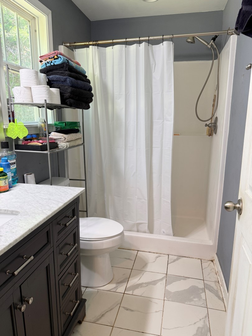 1381 Turkey Creek Road Dickson, TN 37055 - Photo 25 of 35 a bathroom with a granite countertop sink a toilet and shower