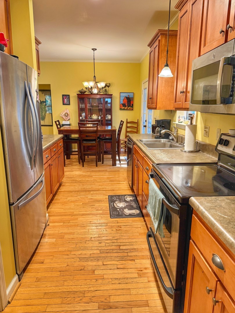 1381 Turkey Creek Road Dickson, TN 37055 - Photo 8 of 35 a kitchen with granite countertop a refrigerator a stove top oven a sink dishwasher and wooden cabinets with wooden floor