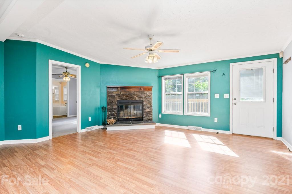 151 Butternut Lane Rutherfordton, NC 28139 - Photo 3 of 24 a view of an empty room with a fireplace and a window