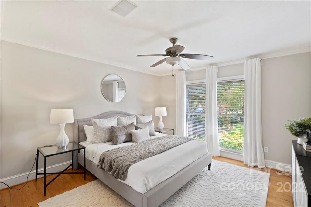 1435 Lilac Road Charlotte, NC 28209 - Photo 17 of 33 a bedroom with a large bed and a chandelier